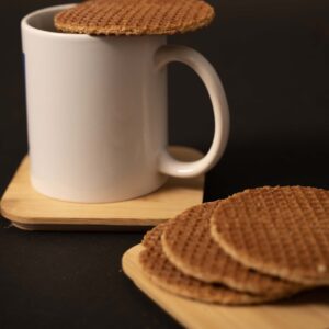 a white mug with a stroopwafel on top
